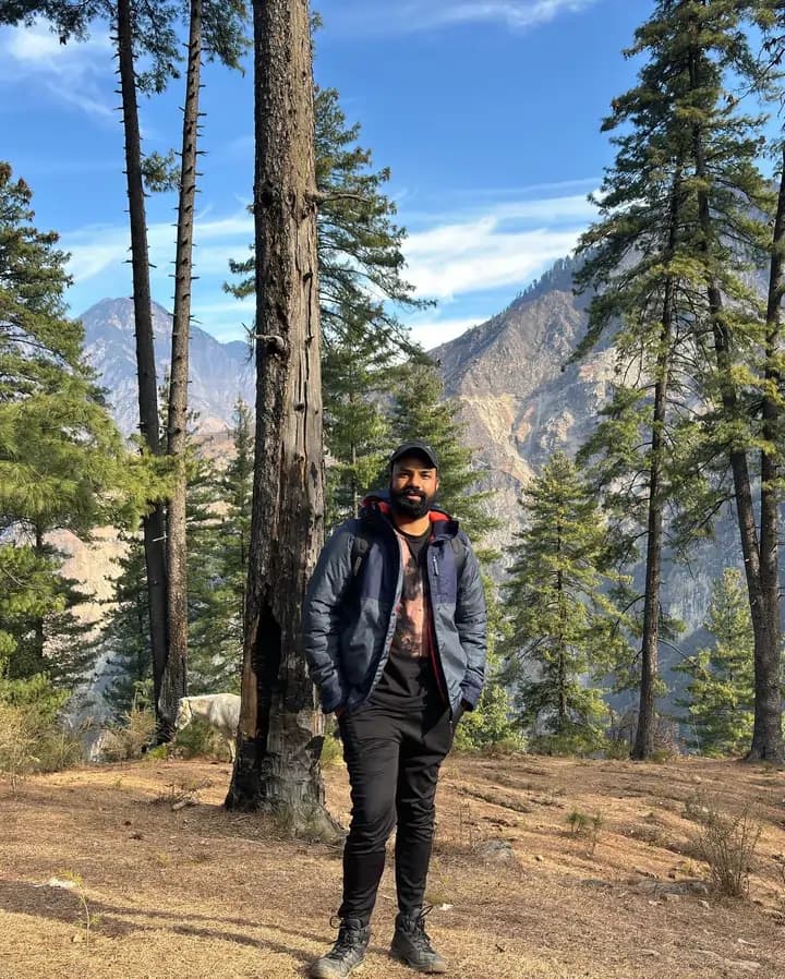 Saurabh Mehta standing outdoors in a mountain landscape